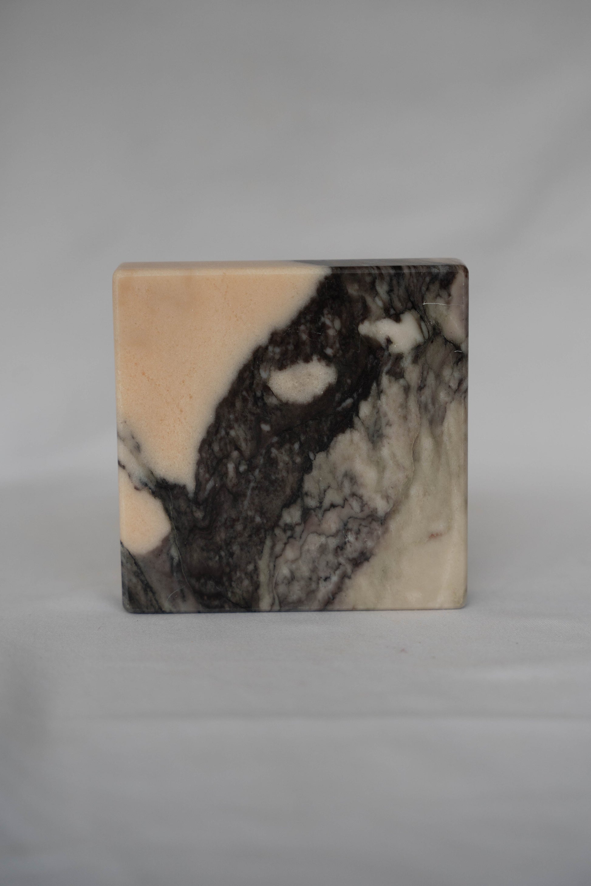Marble-patterned square tile on a gray background